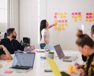 woman placing sticky notes on wall