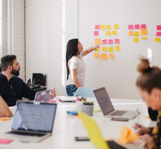 woman placing sticky notes on wall