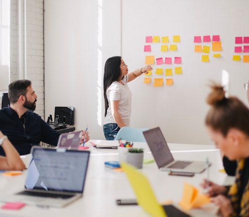 woman placing sticky notes on wall