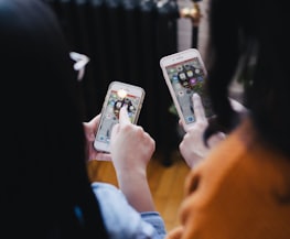 two women operating smartphone