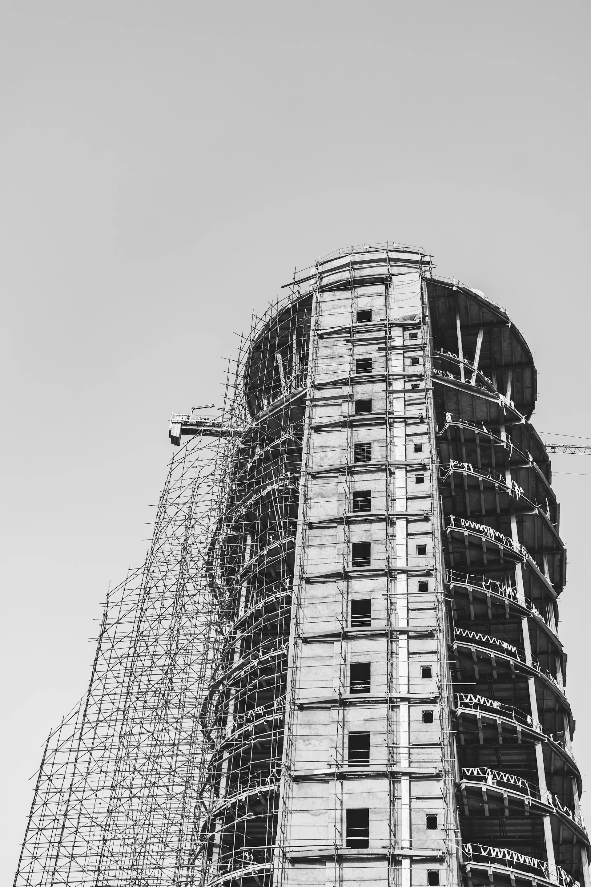 grayscale photo of construction of high-rise building