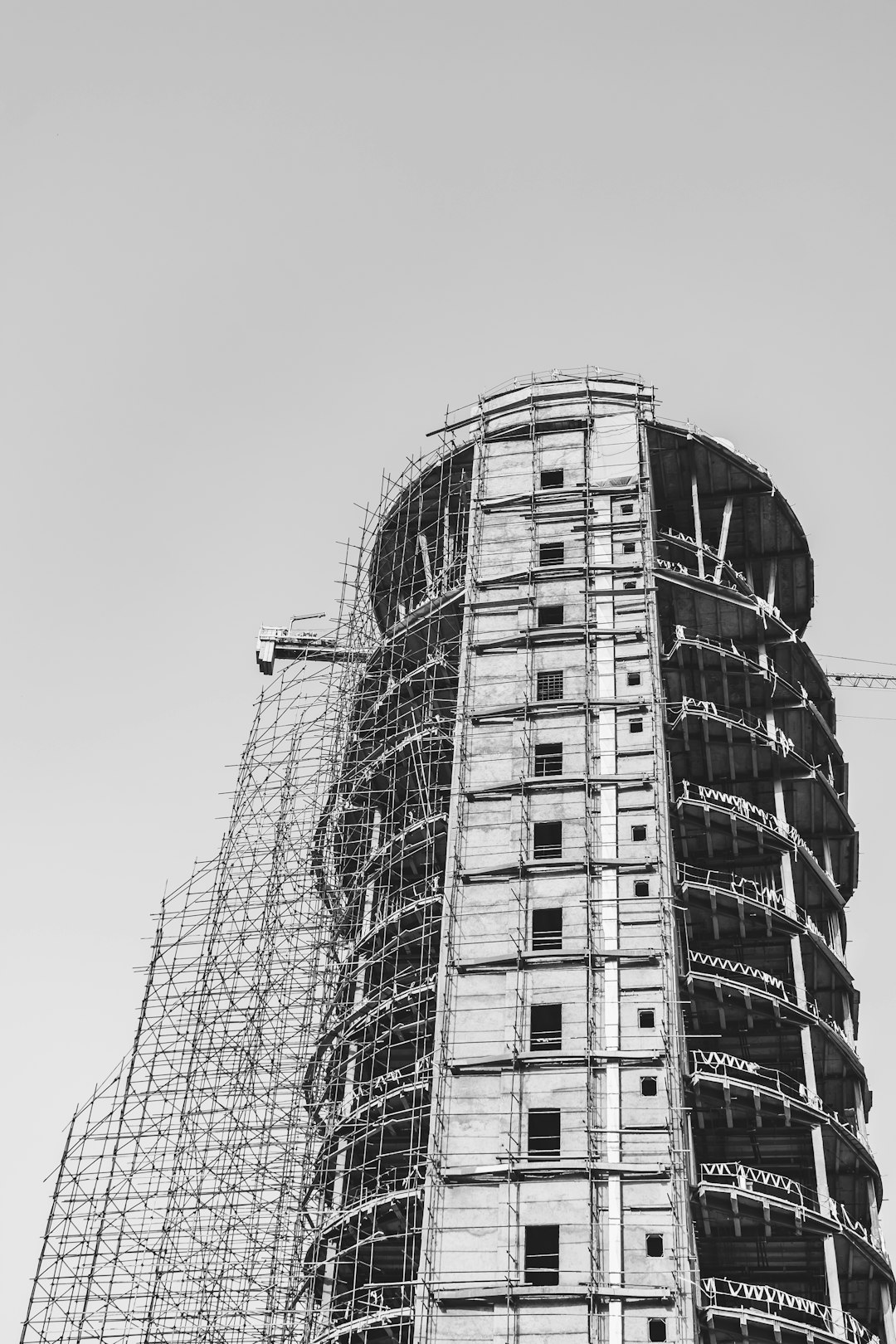 grayscale photo of construction of high-rise building