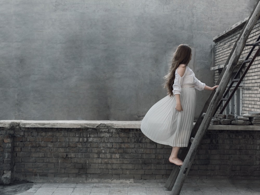 woman standing on step ladder