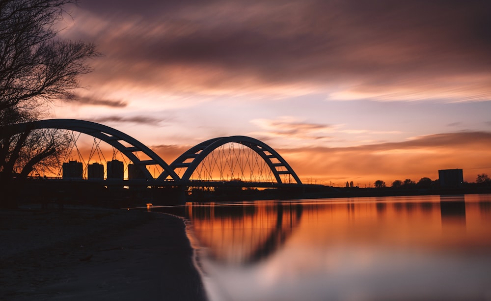 silhouette photography of bridge during golden hour