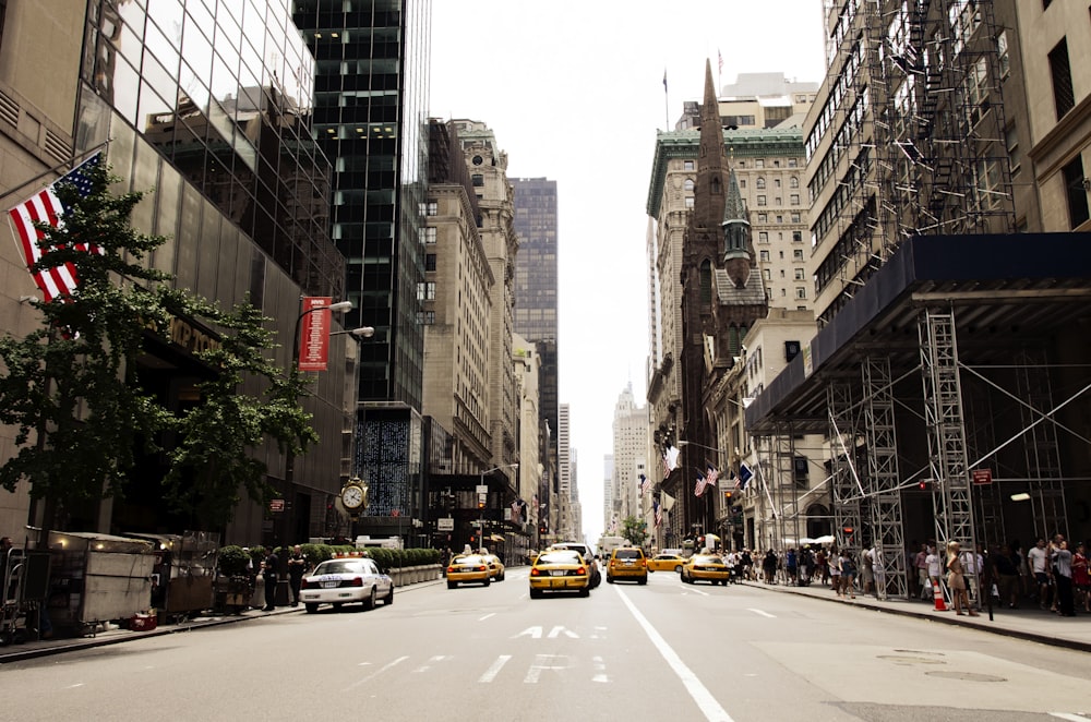 cars on road near high-rise buildings