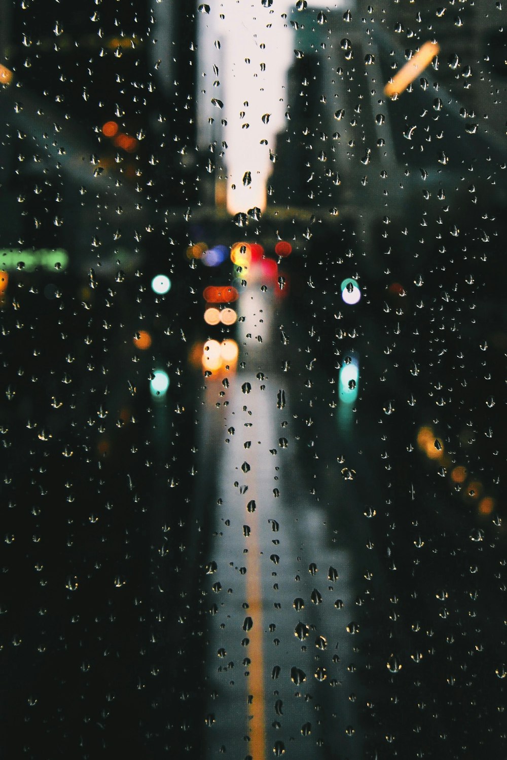 selective focus photography of drops of water on glass sheet