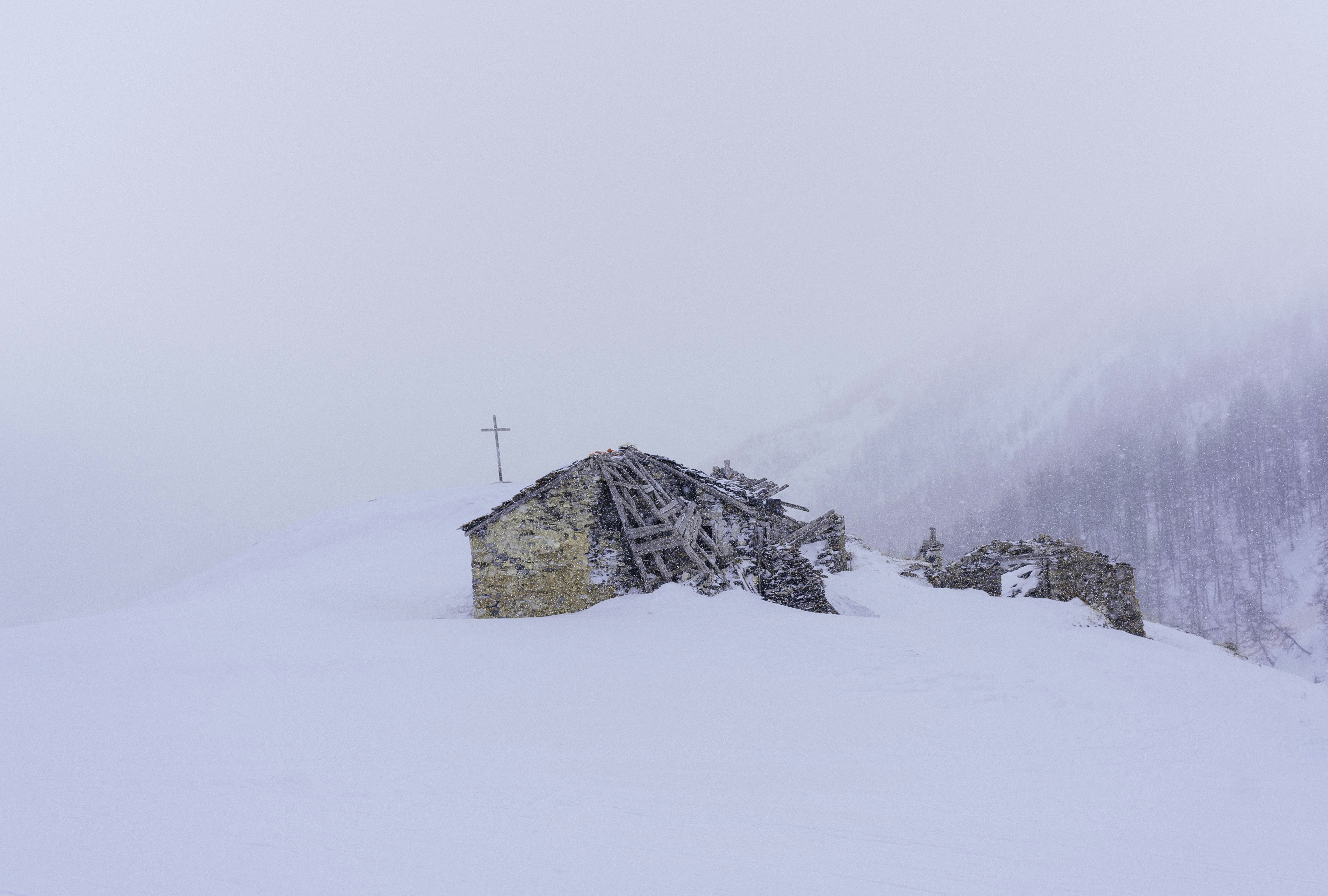 cross on top of snow mountain