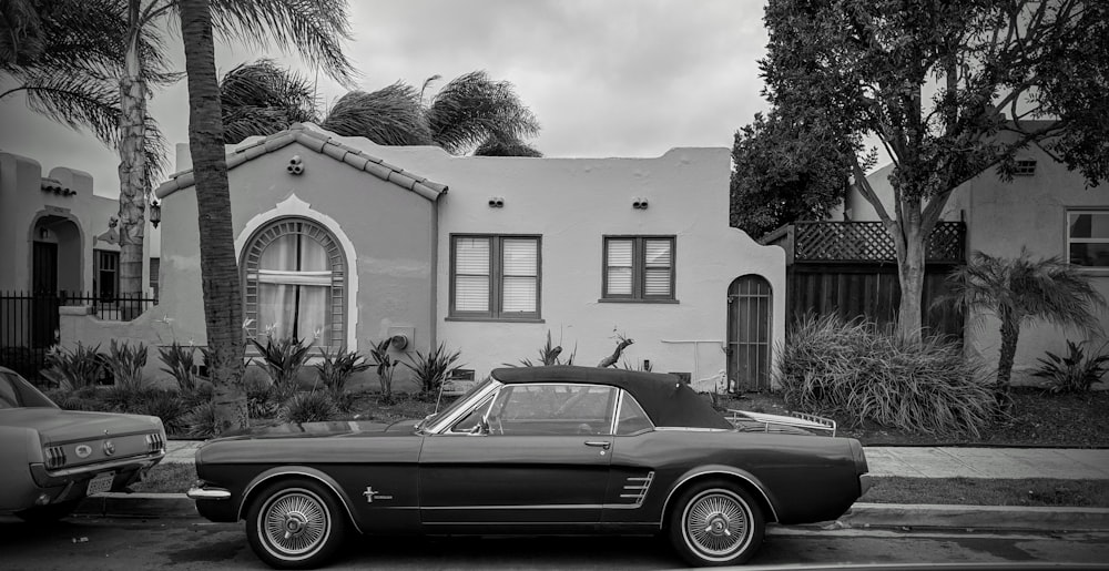 Ford Mustang park parked outside white concrete building during daytime