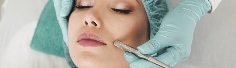 woman doing liposuction on her face