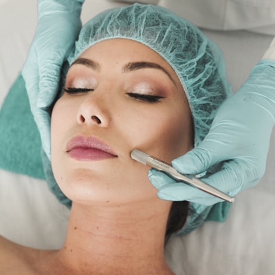 woman doing liposuction on her face