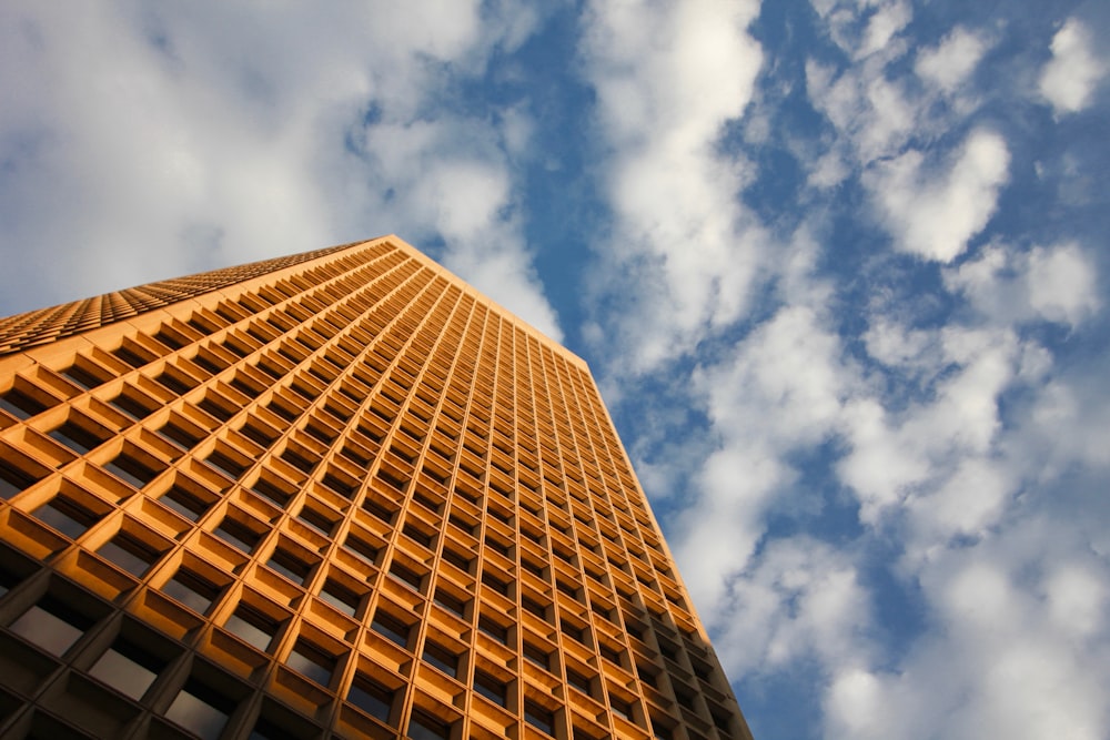 low angle photo of yellow high rise building