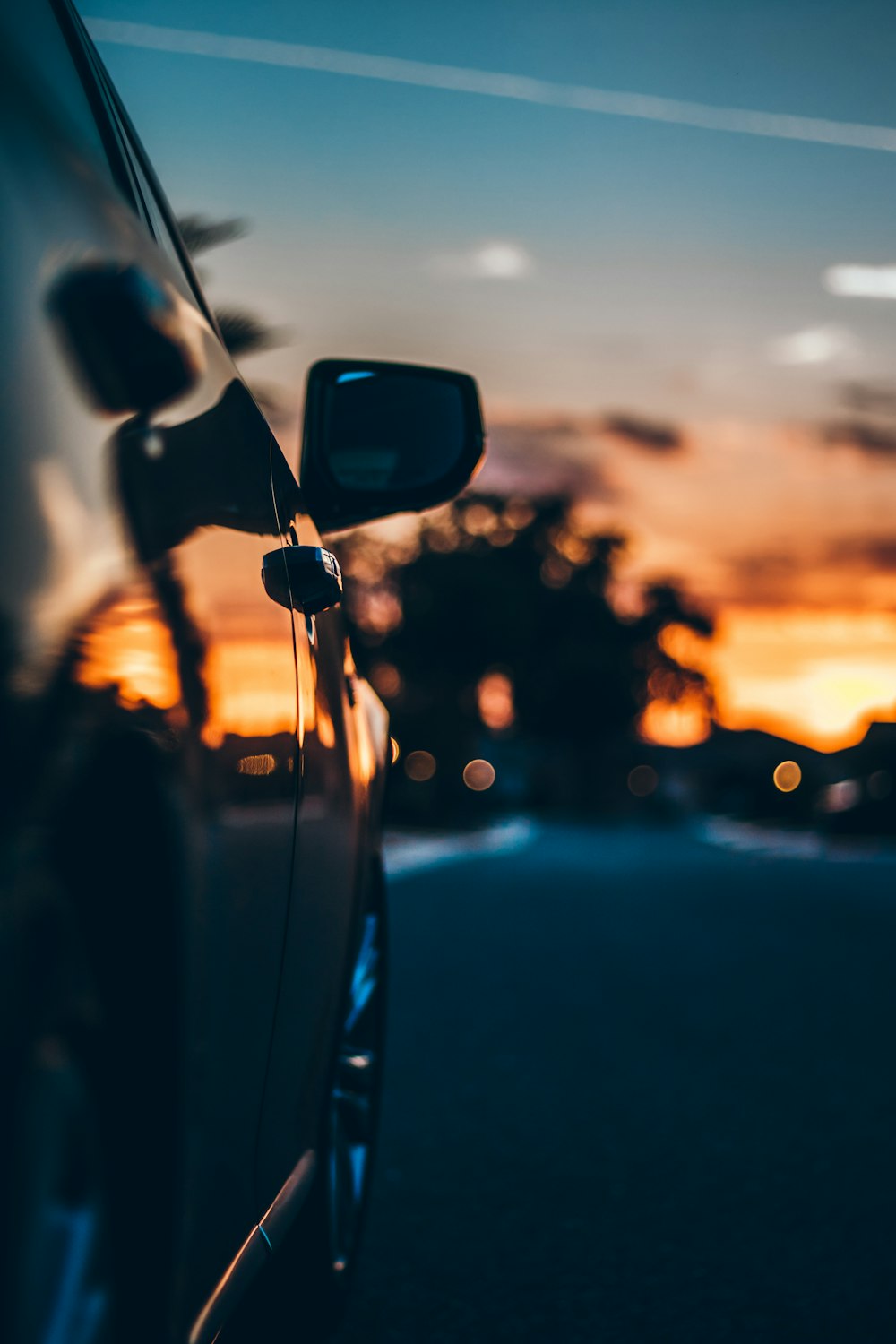 sunset reflecting on shiny black car door