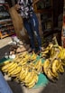 Photo of a man holding a natural product in a sunny Rio de Janeiro street market