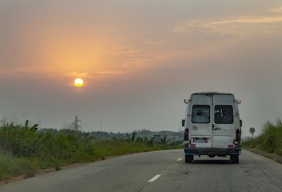 Delivery van driving on an Italian highway at sunset.