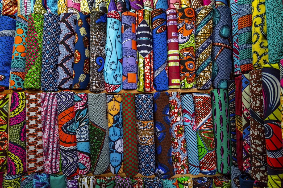 Rolled fabric bolts in a quilting shop showing various patterns and colours