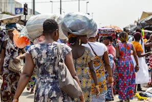 A colorful street market scene in Lagos bustling with people and vibrant fabrics