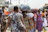 Image of a man carrying a vibrant cotton handblock print bag while walking in a market.