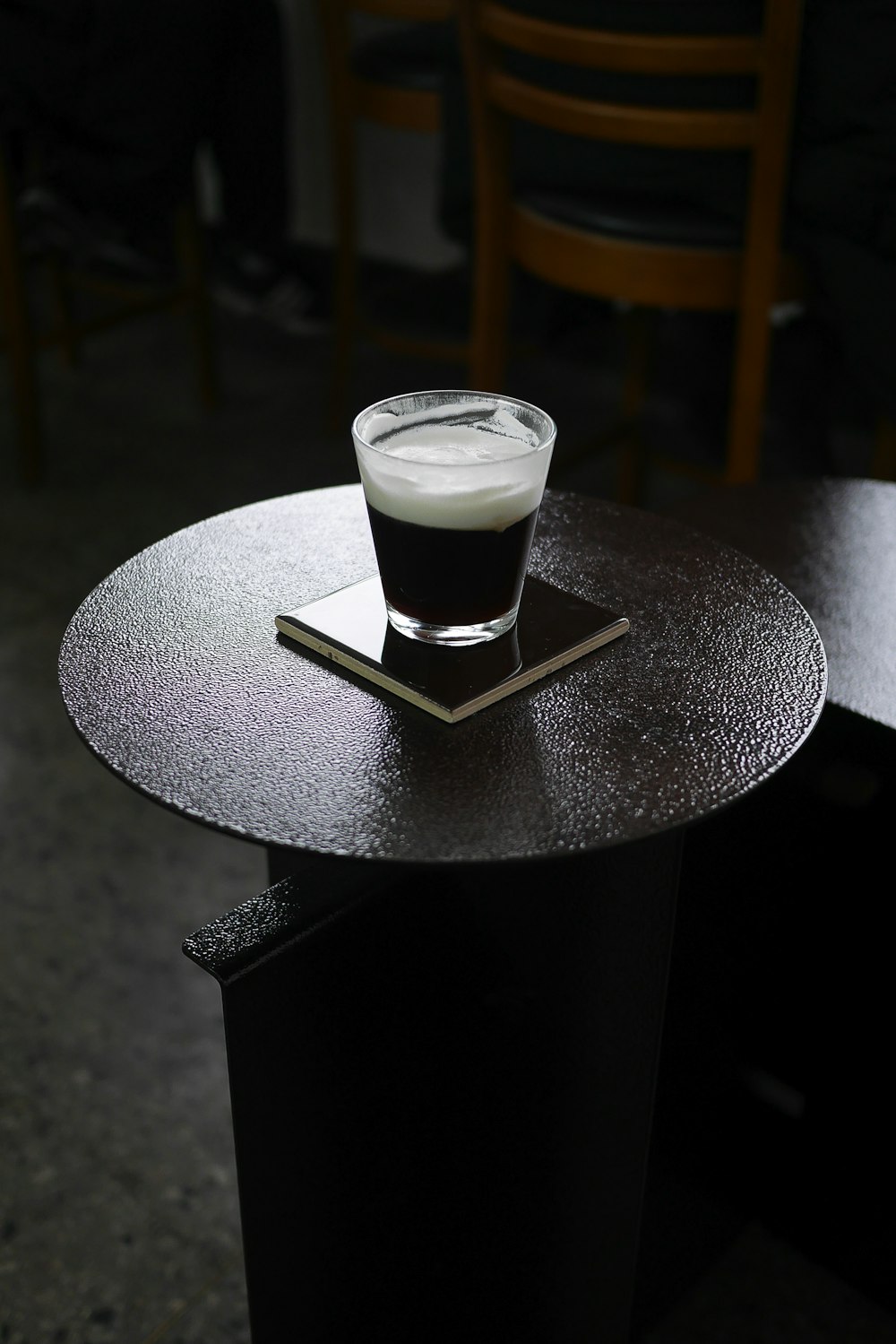 clear glass cup on round brown table