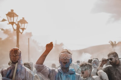 man wearing gray hoodie holi google meet background