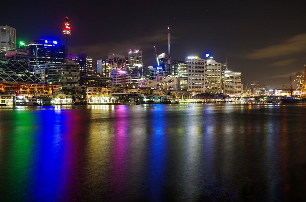 lighted city beside sea