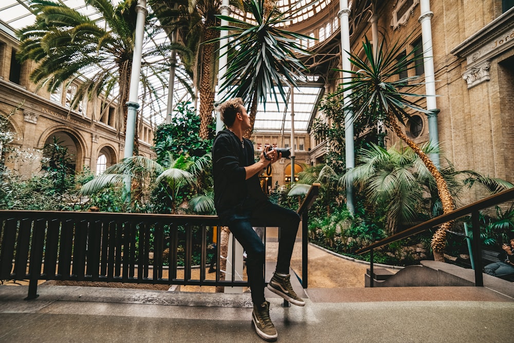 a man sitting on a bench in a building