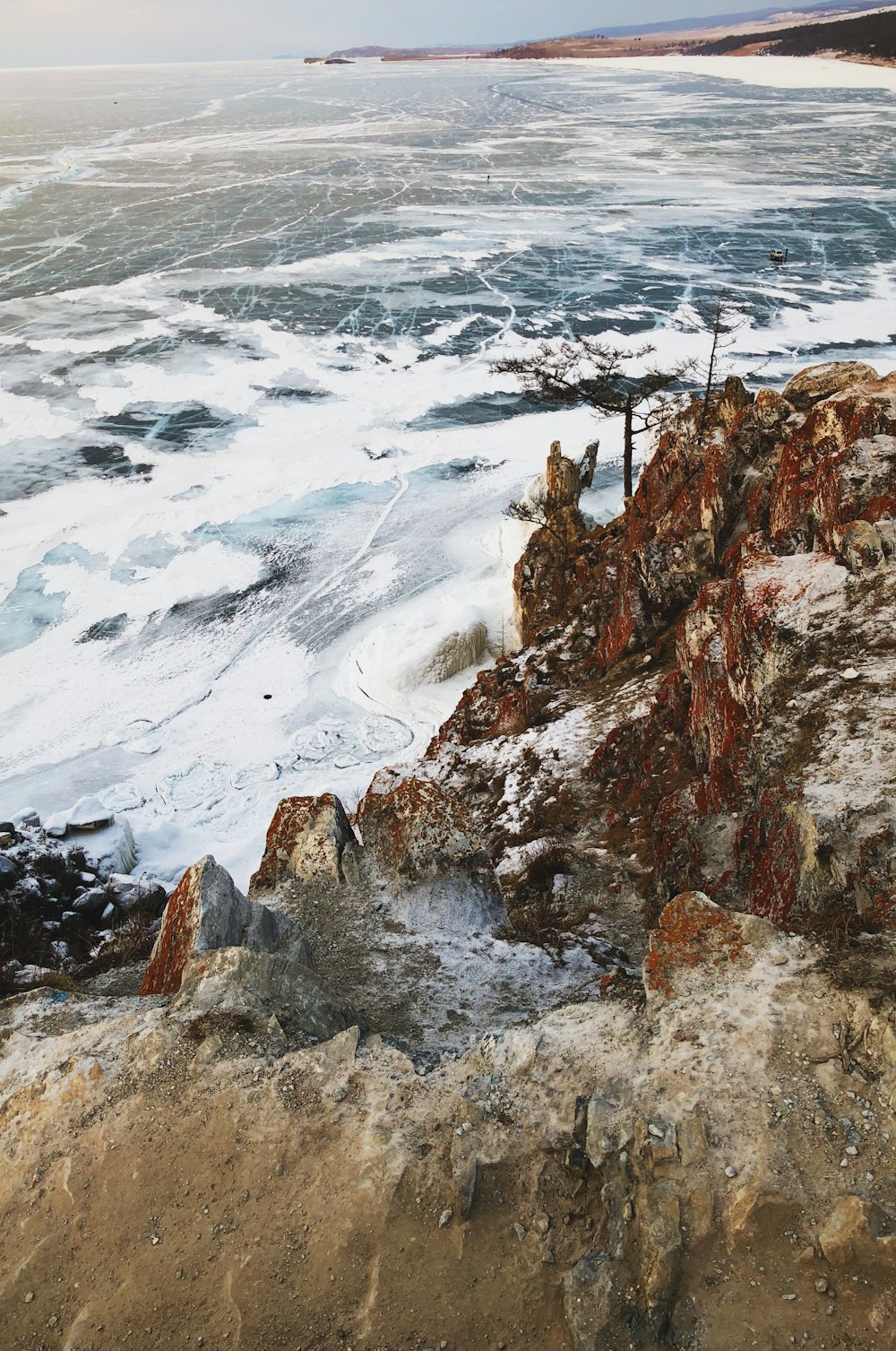 waves crashing on brown rock