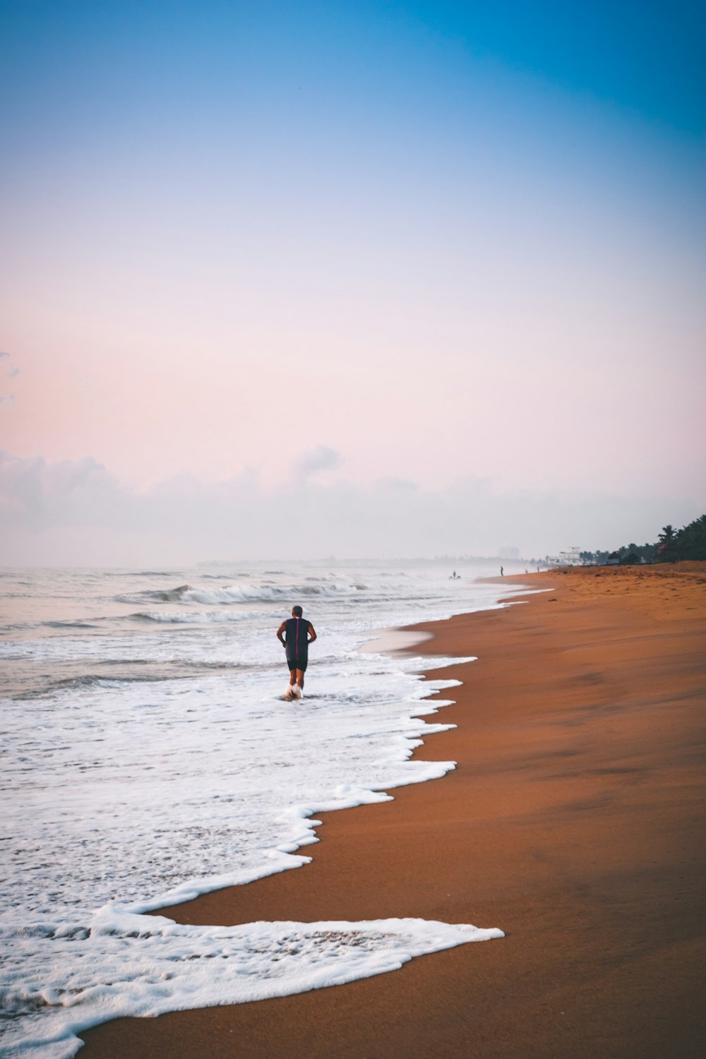 man walking on shore during daytime