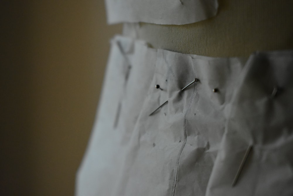 a close up of a piece of paper with pins on it