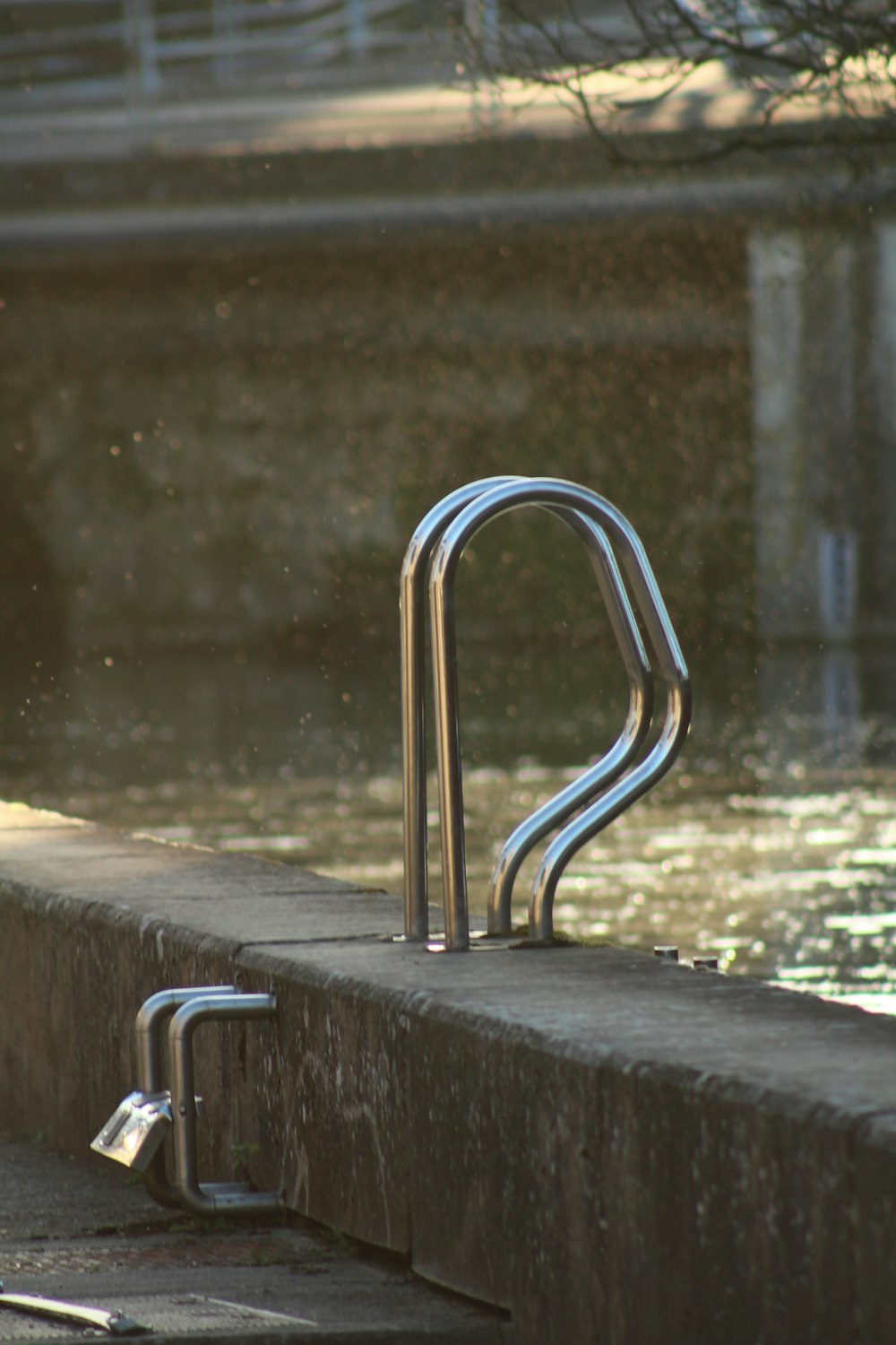 gray stainless steel pool handle bar during daytime