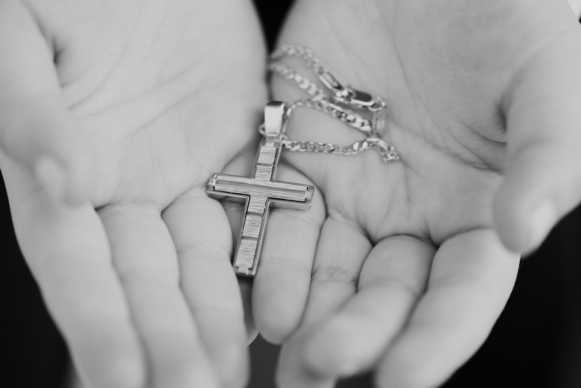 silver-colored necklace with cross pendant
