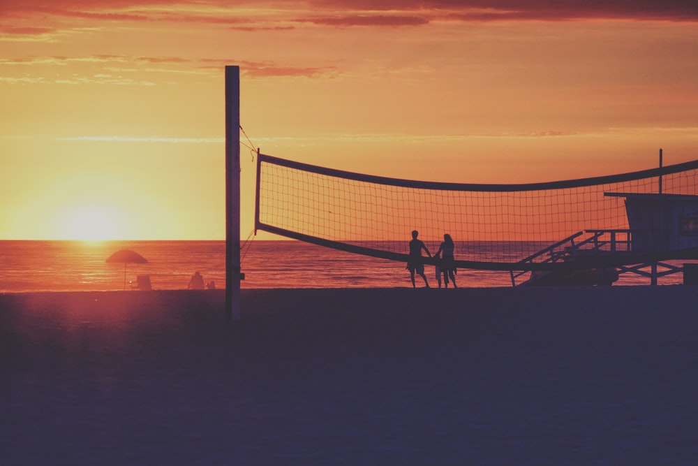 couples standing on seashore