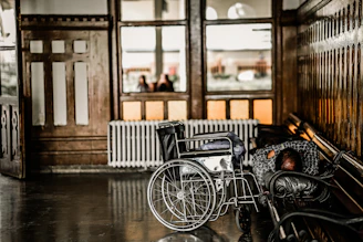 gray wheelchair beside person sleeping on bench