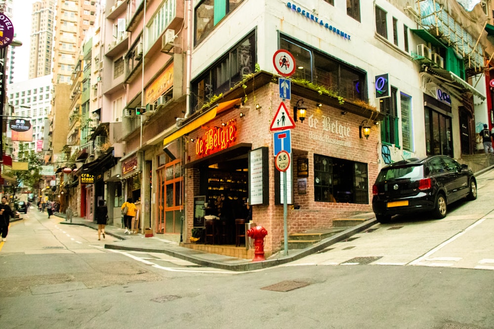 black car parked beside building