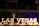 Bold, illuminated letters spell out 'Las Vegas' against a dark background, with vibrant colors and a blurred backdrop suggesting a lively, bustling environment.
