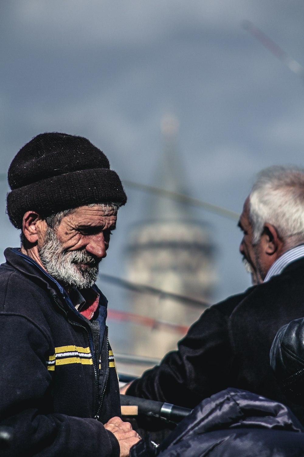 two men standing beside grilll