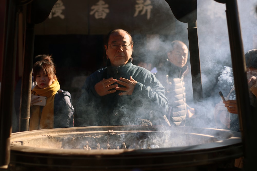 man standing in front of firepit