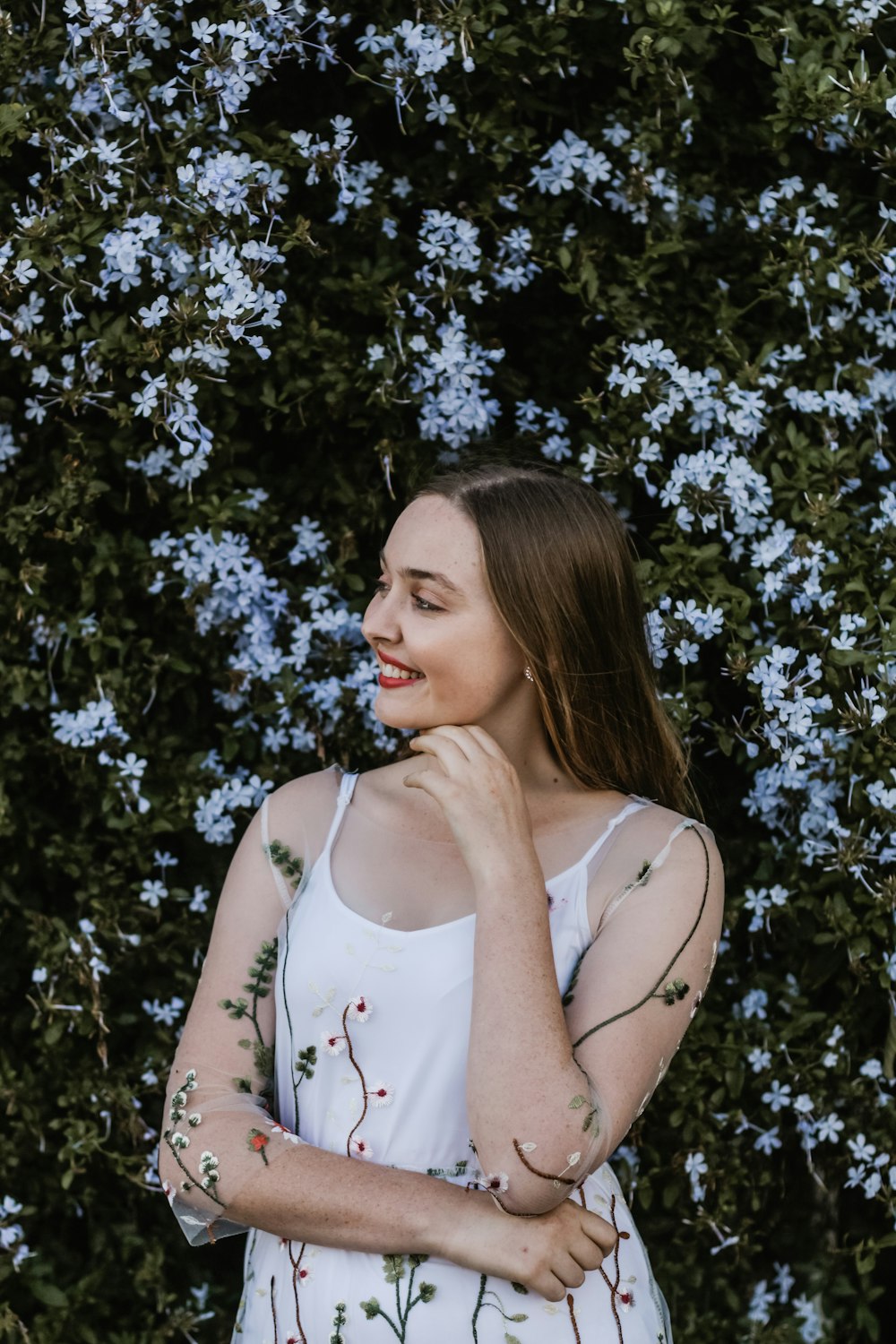 smiling woman wearing white spaghetti strap dress