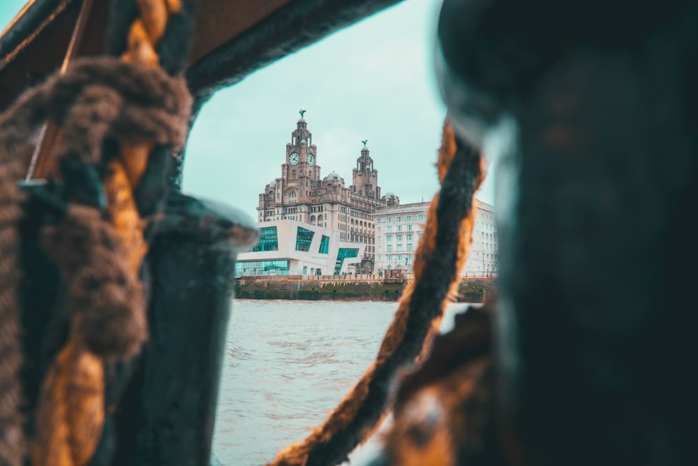 brown concrete building near body of water