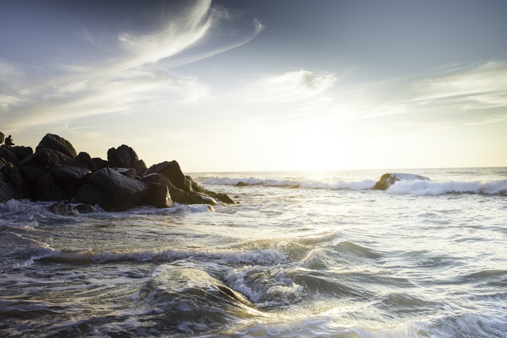 body of water and pile of rocks