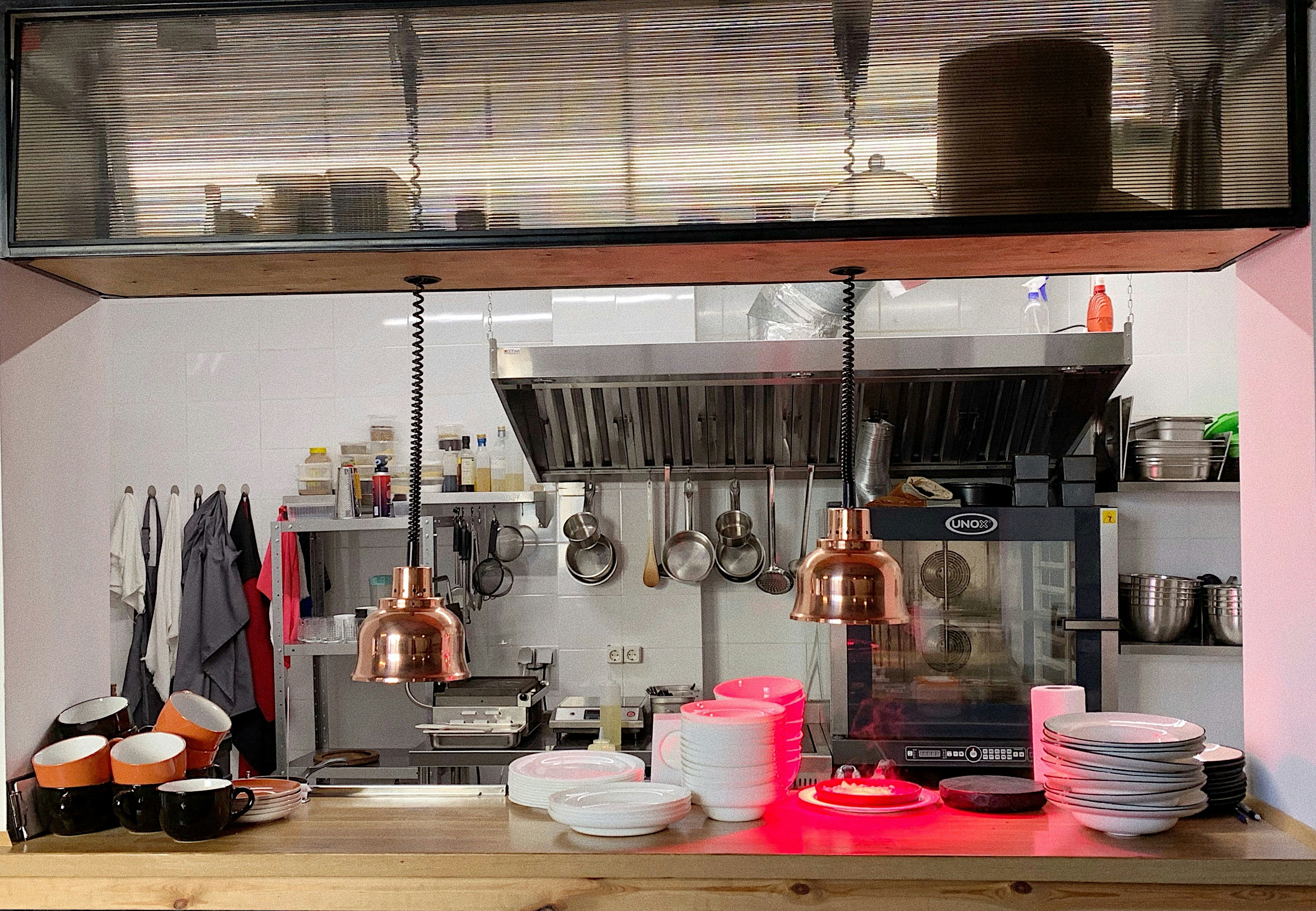Stainless steel commercial kitchen setup with elegant industrial design and gold accents.