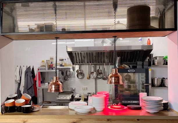 A spacious commercial kitchen equipped with modern appliances.