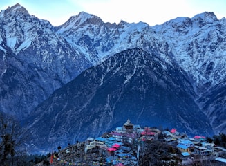 Snow-capped Atlas Mountains towering over a peaceful Berber village.