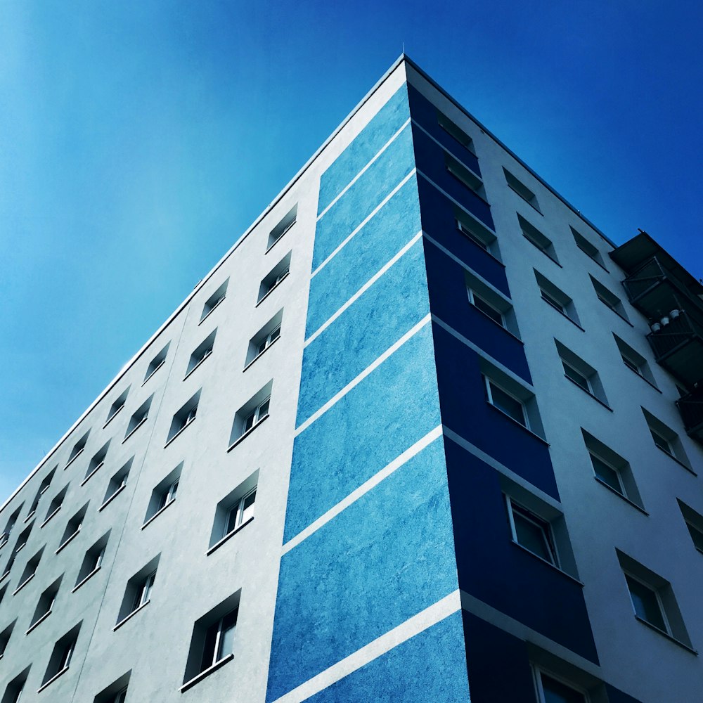 昼間の青空下の灰色と青の建物の浅い焦点撮影