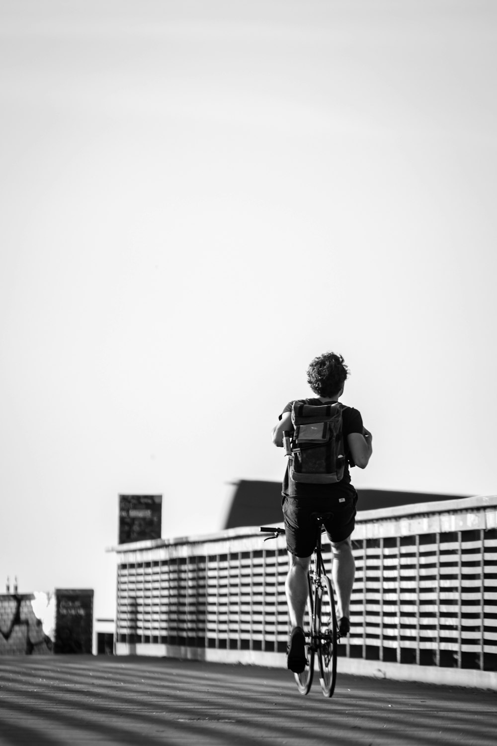 person riding road bike in black and white photo
