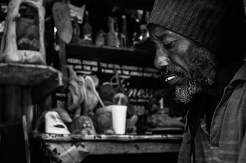 A black and white photo capturing a thoughtful entrepreneur at work.