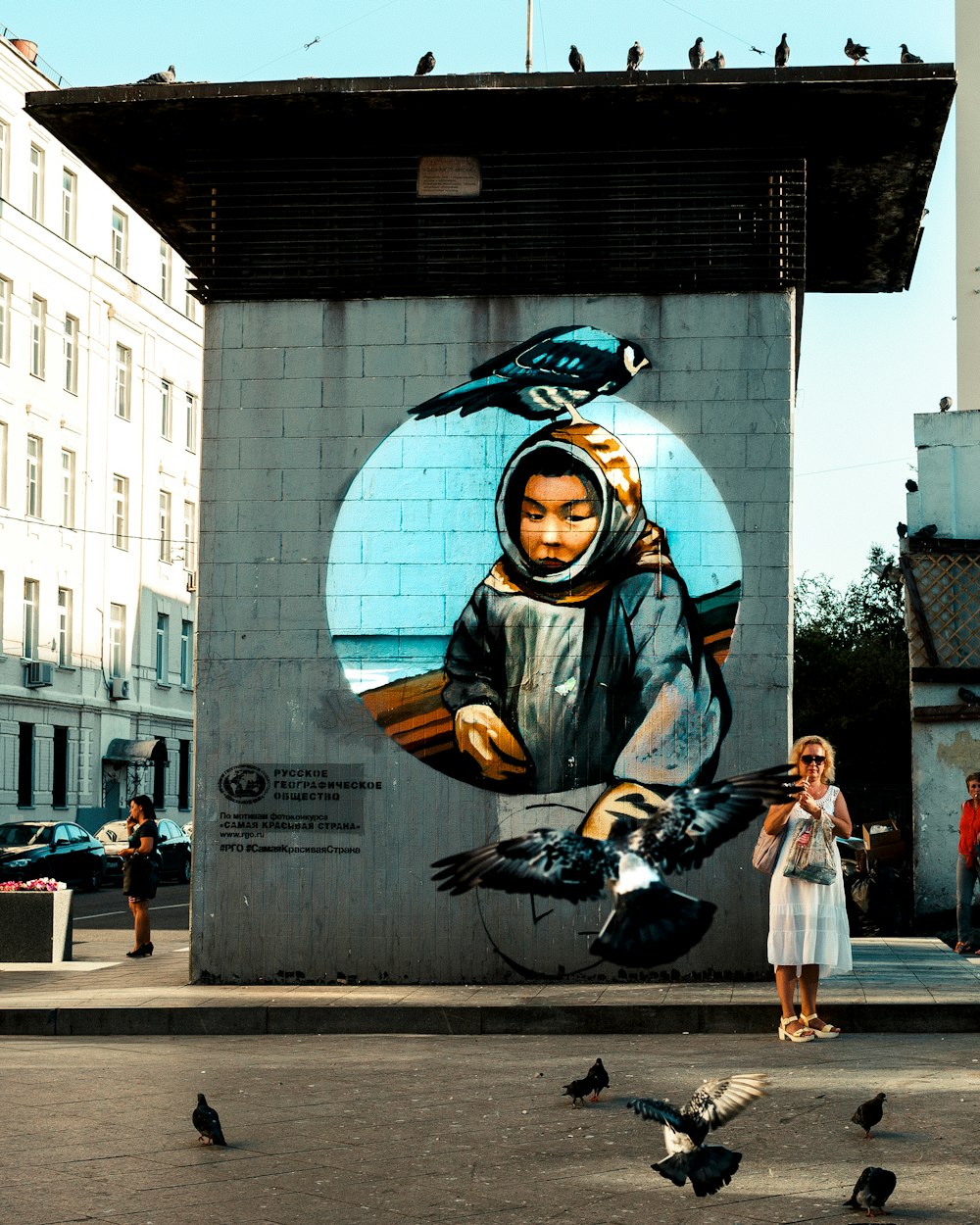 woman standing near mural painting