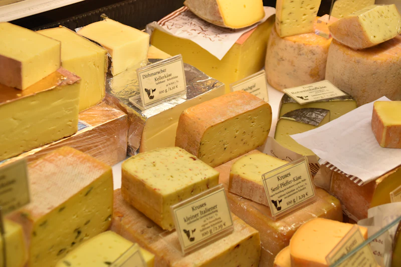 Wedges and wheels of farmhouse cheese displayed on a counter
