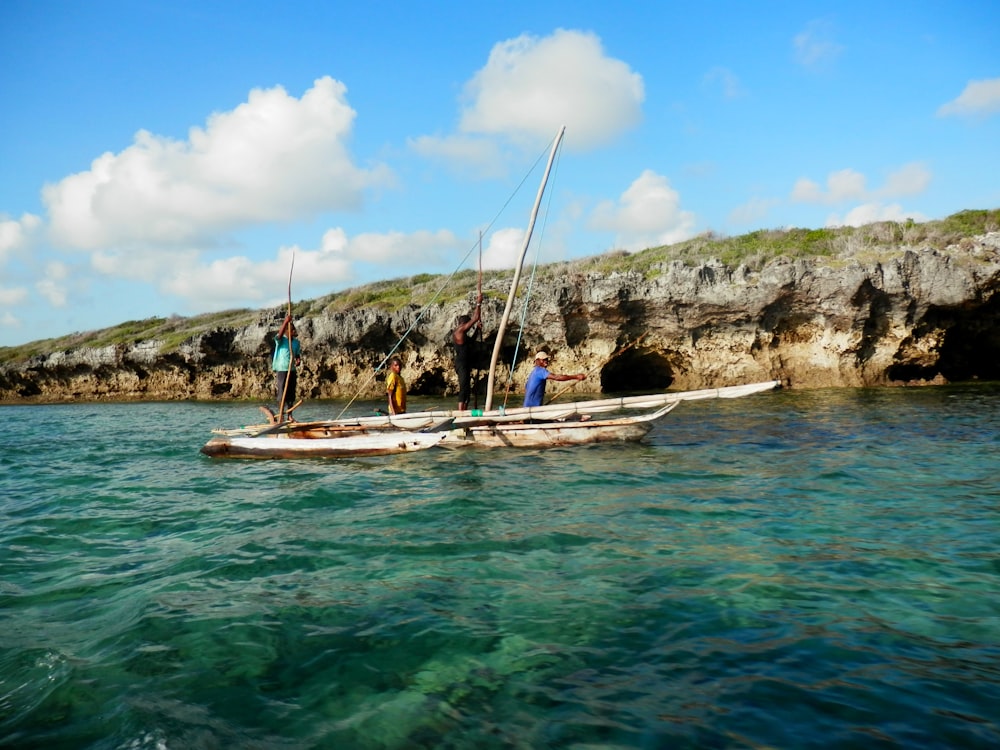 person riding white boat fishing on sea