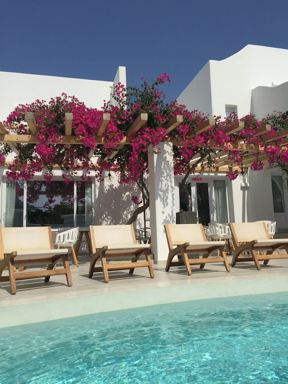 three deck chairs beside outdoor pool