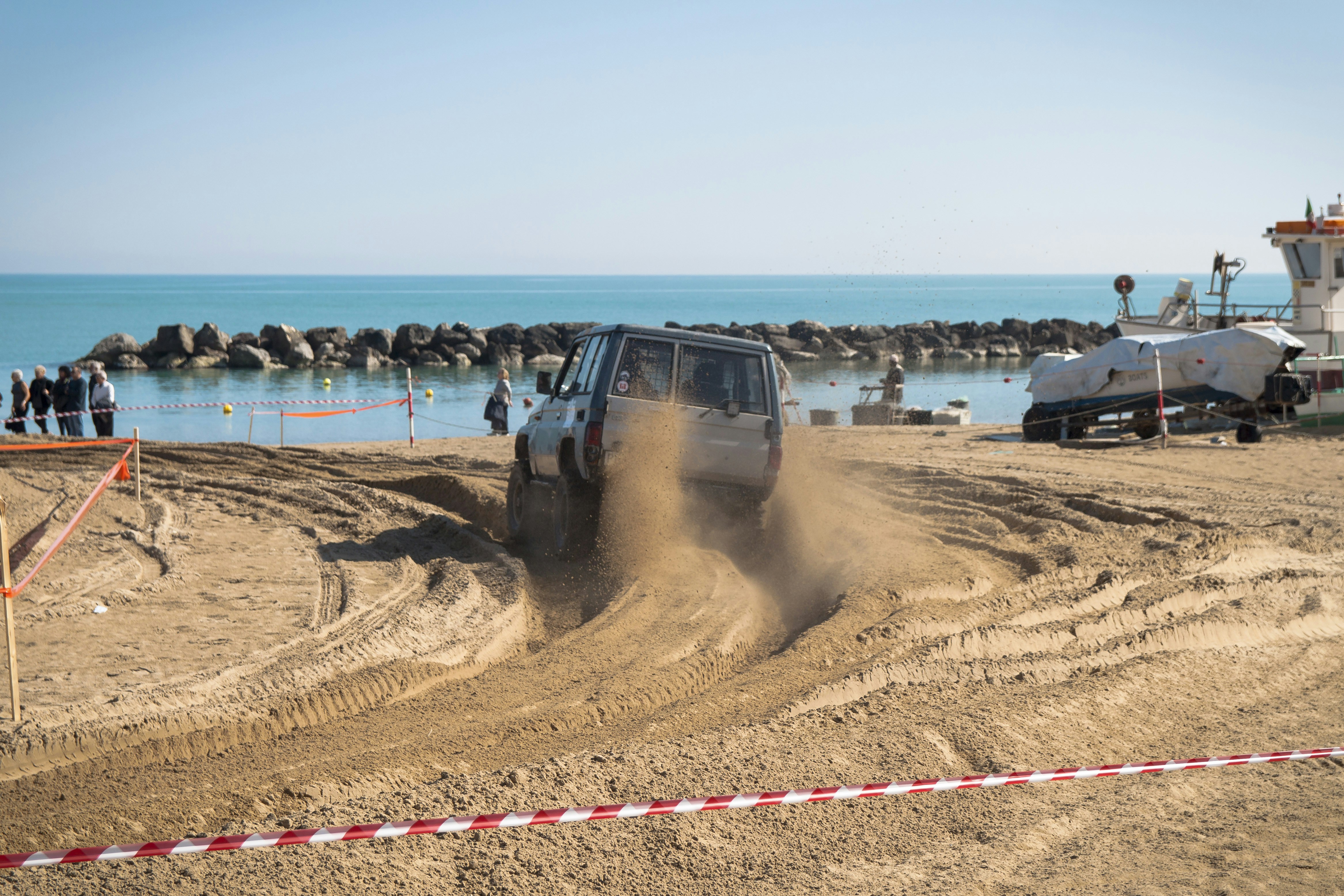 white vehicle on sand at daytime